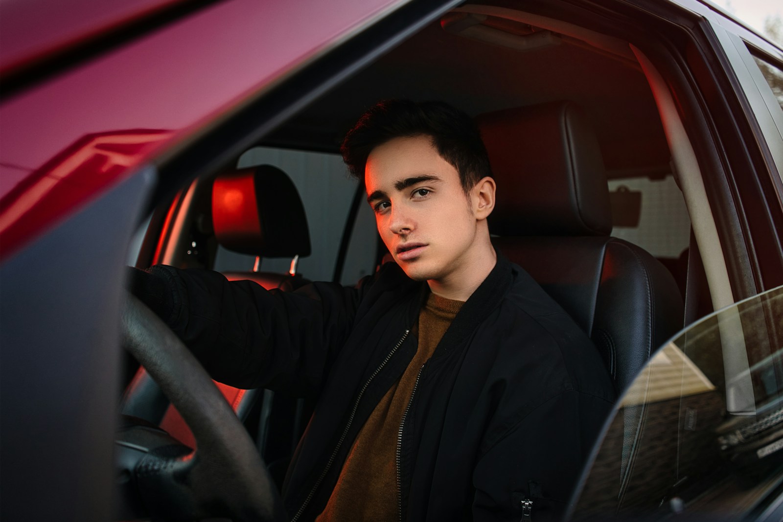 uninsured motorist man in black suit jacket sitting on car seat